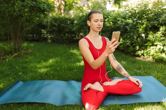 a young lady wearing red suit doing yoga at the time of sunrise to maintain her bone health and vitamin d deficiency.