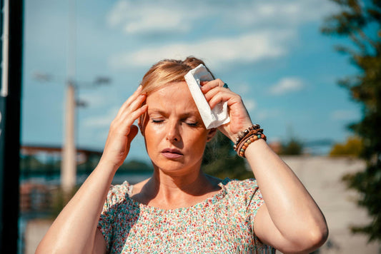 a lady feeling sudden headache during a walk