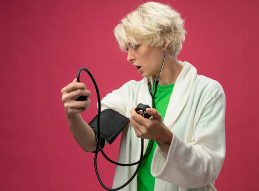 a lady shocked about high blood pressure looking at the phygmomanometer reading